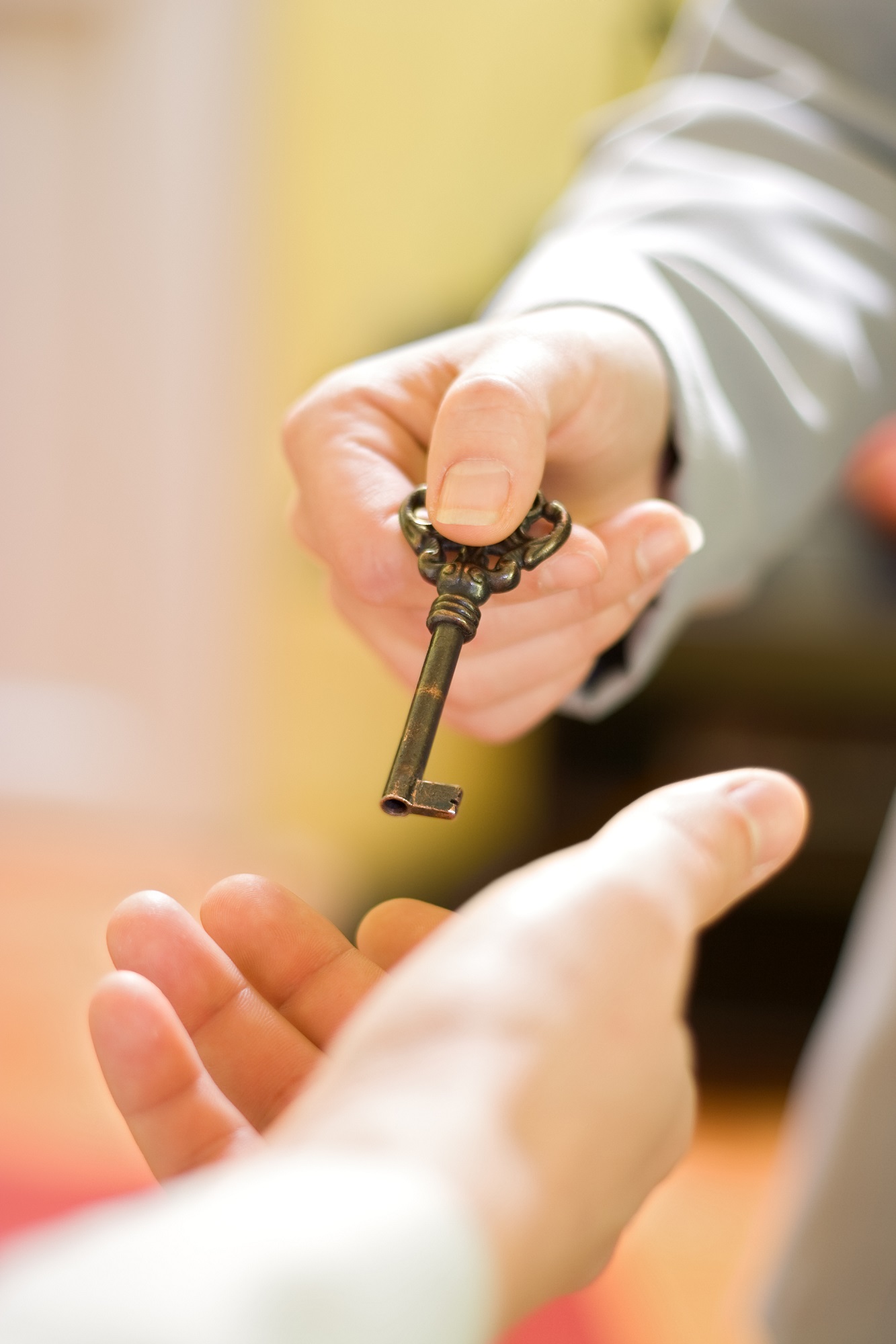 Person handing over key to business